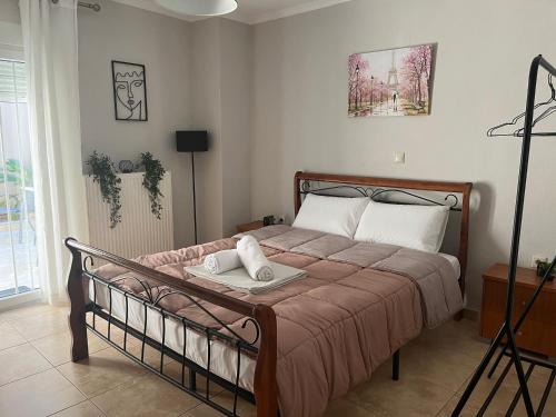 a bedroom with a bed with a wooden frame at Peaceful Nook in Alexandroupoli