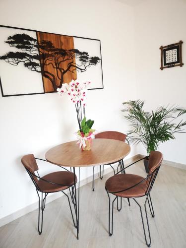 a dining room with a table and chairs with flowers on it at Panorama Suite in Piazza Armerina