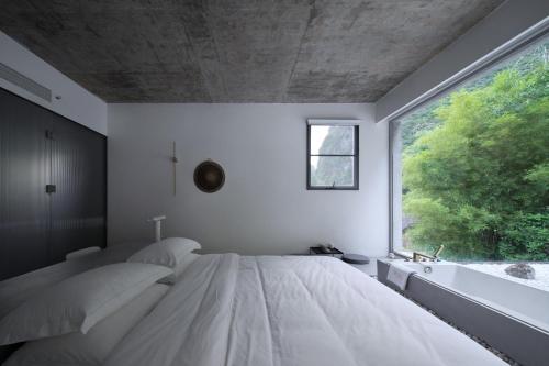 Ein Bett oder Betten in einem Zimmer der Unterkunft Geemu Resort Yangshuo