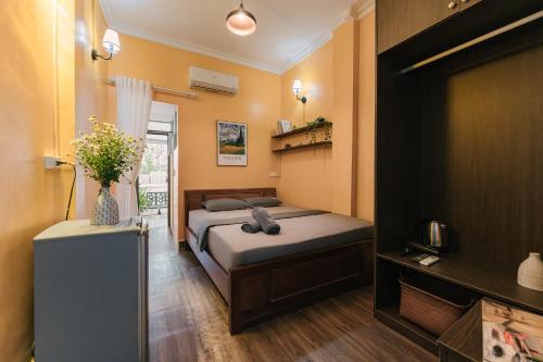 a bedroom with a bed in a room at Bridgo Home, by Hoan Kiem lake side - by Antique in Hanoi