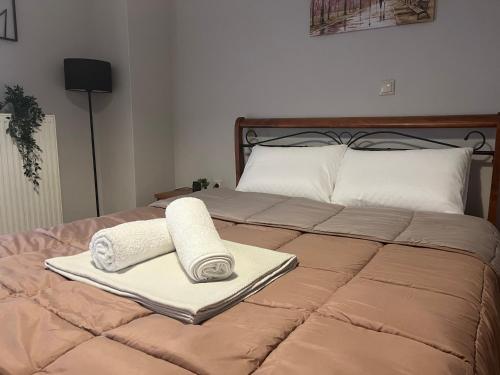 a bed with two towels on top of it at Peaceful Nook in Alexandroupoli
