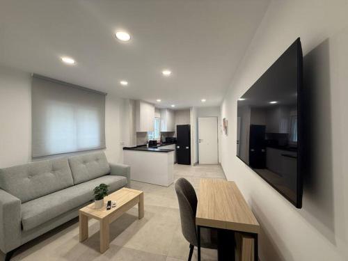 a living room with a couch and a table at Edificio Mañez - Bajo in La Línea de la Concepción