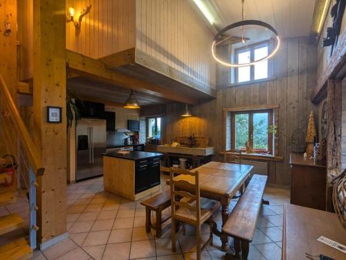 une cuisine avec une table en bois et une salle à manger dans l'établissement Les Jonquilles - 12 pers - pleine nature, à Xonrupt-Longemer