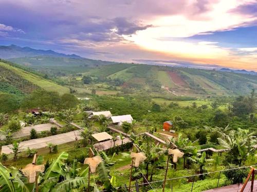 a view of a village in the middle of a valley at Adachi Farmstay Bảo Lộc in Bao Loc