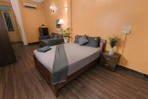 a bedroom with a large bed in a room at Bridgo Home, by Hoan Kiem lake side - by Antique in Hanoi