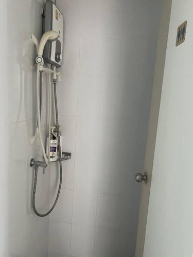 a shower in a bathroom with a shower head at LumpiniC17 in North Pattaya