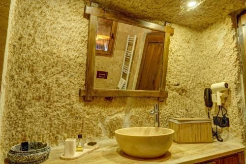 a bathroom with a bowl sink and a mirror at Mizan Cave Cappadocia in Nevsehir