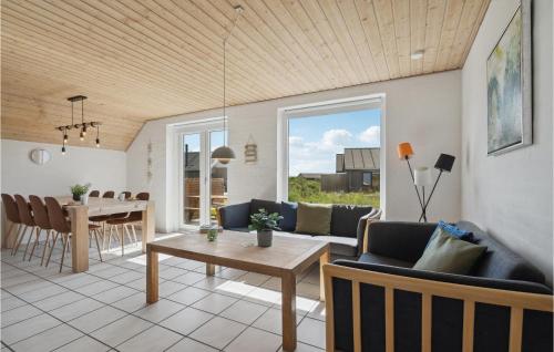 a living room with a couch and a table at Gorgeous Home In Harboøre With Sauna in Harboør
