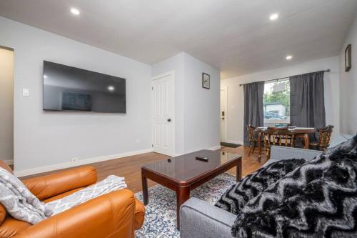 a living room with a couch and a table at Highland Park Upper Suite in Calgary