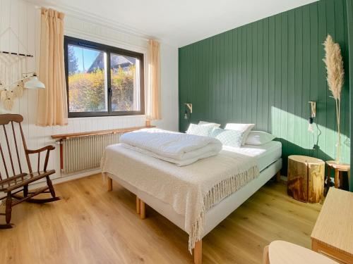 une chambre avec un lit, une chaise et une fenêtre dans l'établissement Maison de montagne, à Passy