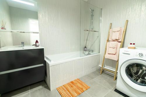 une salle de bain avec une machine à laver et un lave-linge dans l'établissement Appartement cosy 45 m2 avec terrasse, à Gentilly