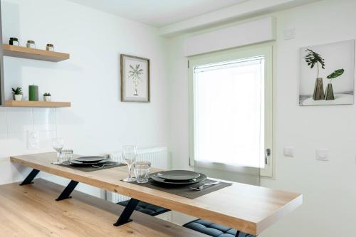 a dining room with a wooden table and a window at Appartement cosy 45 m2 avec terrasse in Gentilly