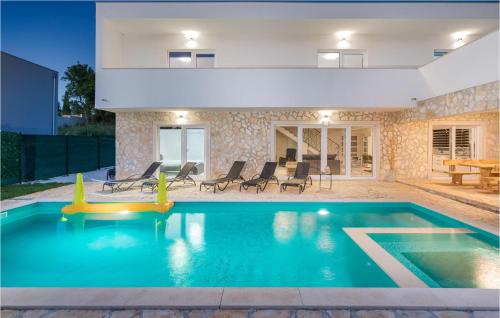 a swimming pool in the backyard of a house at 4 Bedroom Beautiful Home In Jursici in Juršići