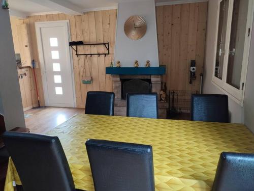a dining room with a yellow table and chairs at Charmante maison proche plage et port in Camaret-sur-Mer