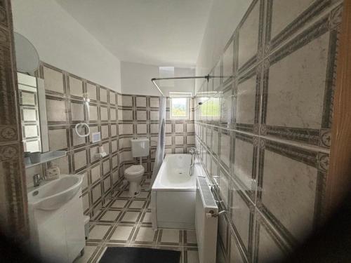 a bathroom with a sink and a toilet at Weinesya Sunset Smida in Beliş