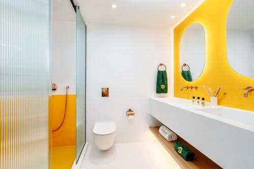 a bathroom with a shower and a toilet and a sink at Croco Mykonos in Tourlos