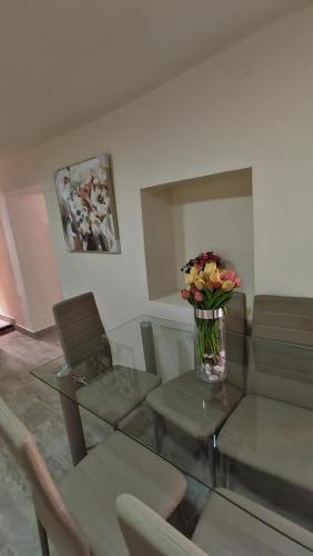 a living room with a vase of flowers on a table at Centro Cusco Inti in Cusco