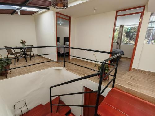 a staircase in a room with a table and chairs at Centro Cusco Inti in Cusco