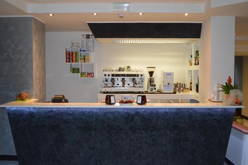 a kitchen with a blue counter top in a room at Canadian Hotel in LʼAquila