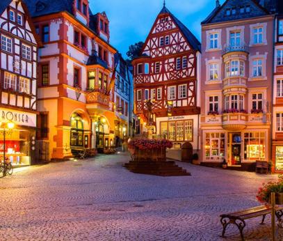 a city street with many buildings and a bench at Komfort FeWo l Moselstay l maximal 4 Personen und Baby I Brauneberg Mosel I WIFI I in Brauneberg