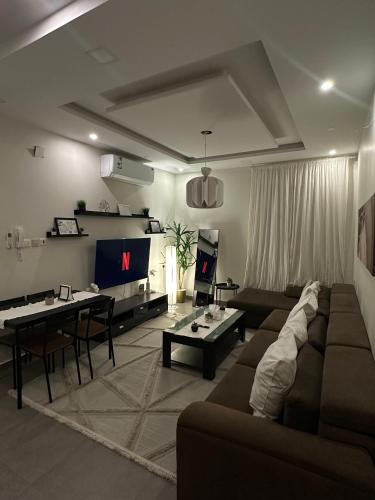 a living room with a couch and a table at Modern cozy apartment in Riyadh