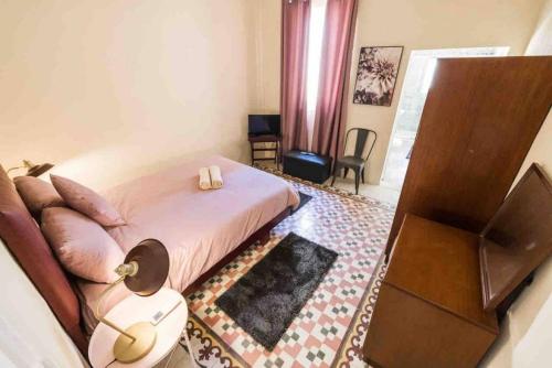 a bedroom with a bed and a dresser and a television at Isla 2 in Cospicua