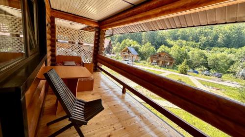 a room with a bench and a large window at Chalet Vedmezhe in Polyana