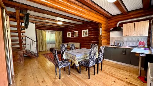 a kitchen and dining room with a table and chairs at Chalet Vedmezhe in Polyana