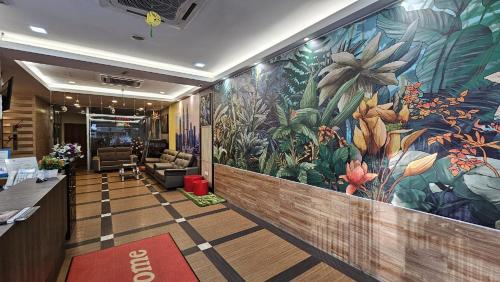 a lobby with a large mural of flowers on the wall at Safari Hotel in Kuala Lumpur