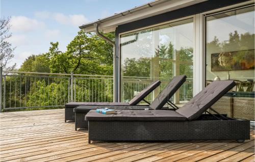 two lounge chairs sitting on a deck at Three-Bedroom Holiday Home In Spottrup in Lihme