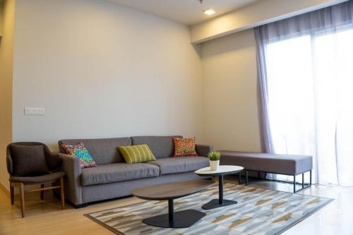 a living room with a couch and a table at Windmill Upon Hills Premium Suite By Rapi Stay in Genting Highlands