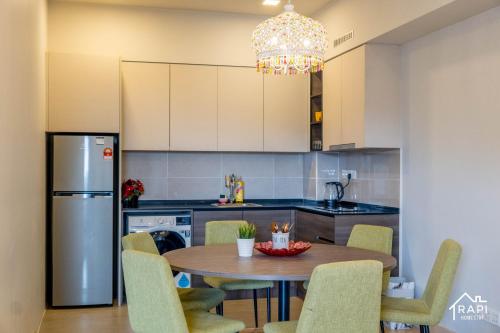 a kitchen with a table and chairs and a chandelier at Windmill Upon Hills Premium Suite By Rapi Stay in Genting Highlands