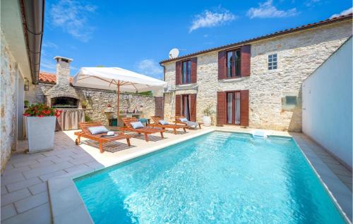 a swimming pool with a patio and a house at Cozy Home In Bale With Sauna in Bale