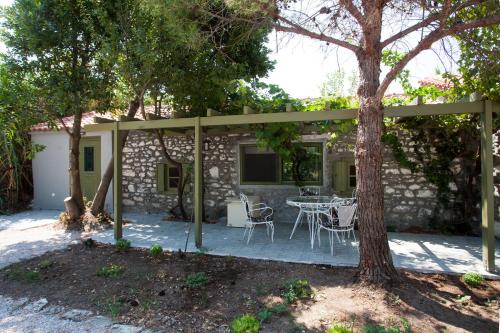 a patio with a table and chairs in front of a building at Chalantra Residence in Skala Eresou