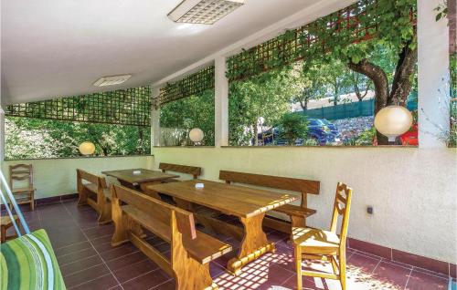a dining room with a wooden table and chairs at Nice Apartment In Povile With Wifi in Povile