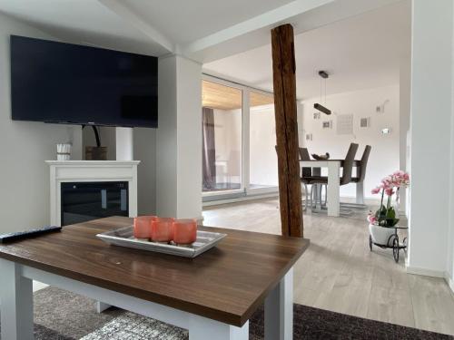 a living room with a table and a tv at Sky in Überlingen