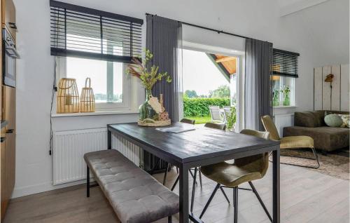 a living room with a table and chairs and a couch at 3 Bedroom Gorgeous Home In Kerkdriel in Kerkdriel