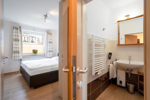 a bathroom with a bed and a sink in a room at DKK5 Ferienwohnung Ostseeperle in Niendorf