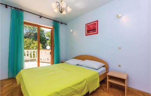a bedroom with a green bed and a window at Nice Apartment In Povile With Wifi in Povile