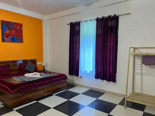 a bedroom with a bed and a window with curtains at Himtrek Stay Kasol in Kasol