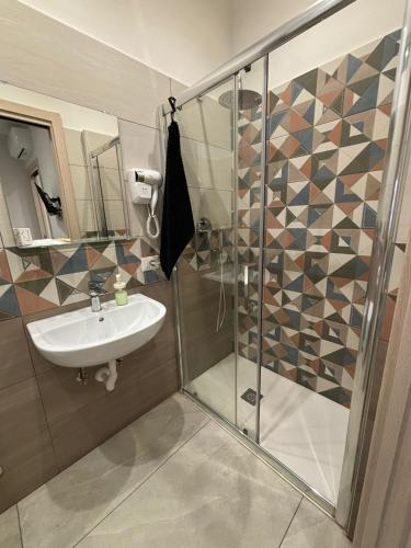 a bathroom with a shower and a sink at La casa di Flò in Ercolano