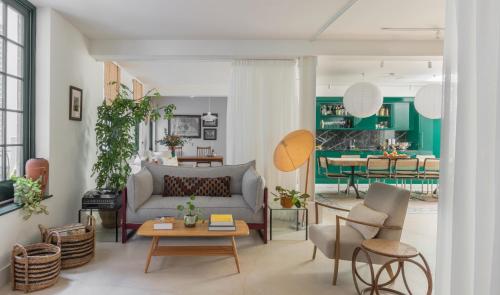a living room with a couch and a table at Mason & Fifth, Bermondsey in London