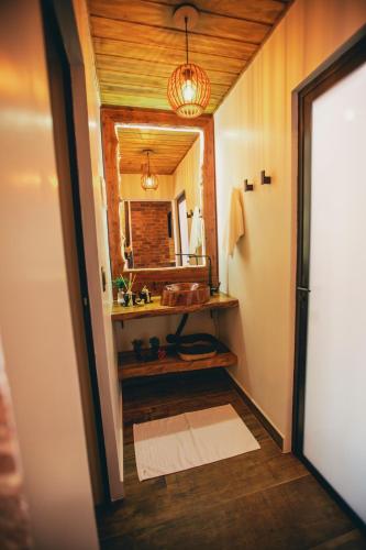 a bathroom with a sink and a mirror at Pousada Duas Marias in Nova Veneza