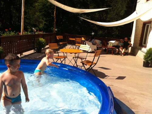two young boys playing in a swimming pool at Dom Nad Wodospadem in Miedzygorze