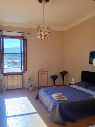 a bedroom with a bed and a chandelier at La Divina guest house in Pontassieve