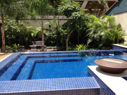 a swimming pool with a toilet sitting next to it at Estúdio Vila Madalena in Sao Paulo