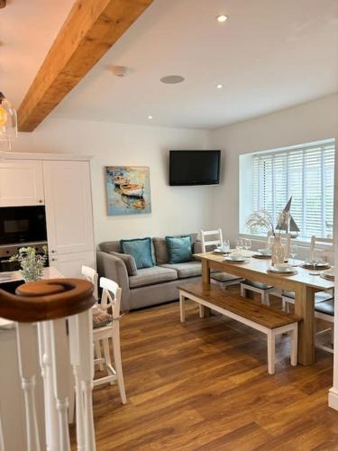 a living room with a table and a couch at House in the heart of Pembroke in Pembroke