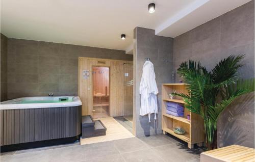 a bathroom with a tub and a plant in it at Amazing Home In Biograd With Kitchen in Biograd na Moru