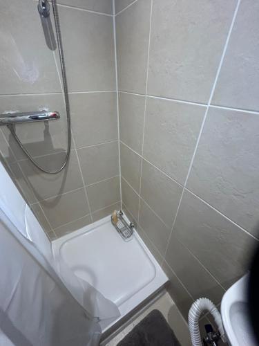 a small bathroom with a shower and a toilet at Cosy rooms near Gatwick Airport in Ifield