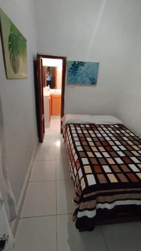 a bedroom with a bed in the corner of a room at Finca los Martinez - Tamesis - Vereda San Isidro in Támesis